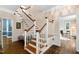 Elegant foyer with a staircase, hardwood floors, and stylish trim, exuding classic charm at 1909 Ira Rd, Efland, NC 27243