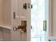 Close up of an entry door with a brass knob, key, and hardware at 1909 Ira Rd, Efland, NC 27243