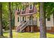 Beautiful home exterior with a porch, brick foundation, stairs, and a well-maintained lawn at 1909 Ira Rd, Efland, NC 27243