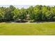 Expansive front yard leading to a house surrounded by trees and lush greenery at 1909 Ira Rd, Efland, NC 27243