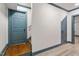 Hallway with hardwood steps, blue trim and doors, and gray floors at 1909 Ira Rd, Efland, NC 27243