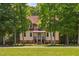 Charming two-story home with a manicured lawn and mature trees at 1909 Ira Rd, Efland, NC 27243