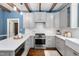 This kitchen features gray cabinets, stainless steel appliances, an island and white subway tile backsplash at 1909 Ira Rd, Efland, NC 27243