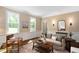 Living room features two large windows, wainscotting, hardwood floors and neutral colored decor at 1909 Ira Rd, Efland, NC 27243