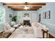 Living room featuring exposed wood beams, fireplace with mantel, and plush seating at 1909 Ira Rd, Efland, NC 27243