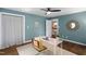 This bright office has a ceiling fan, light blue walls, and view of the staircase at 1909 Ira Rd, Efland, NC 27243