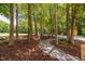 Gravel path winding through mature trees and landscaping at 1909 Ira Rd, Efland, NC 27243