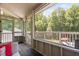 Enclosed back porch with natural views, wood floors, and plenty of seating at 1909 Ira Rd, Efland, NC 27243