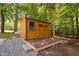 Outdoor shed with double doors and platform with surrounding trees at 1909 Ira Rd, Efland, NC 27243