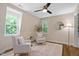 Cozy sitting area with hardwood floors, natural light, and two comfortable chairs at 1909 Ira Rd, Efland, NC 27243