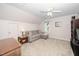 Bonus room features a large grey couch, window views, and ample space at 203 W Hill Dr, Cary, NC 27519