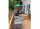Outdoor deck featuring a grill and a dining table, perfect for entertaining at 203 W Hill Dr, Cary, NC 27519