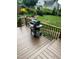 Deck overlooking a green yard, featuring a grill perfect for summer cooking at 203 W Hill Dr, Cary, NC 27519