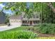 Charming two-story home featuring a welcoming front porch and well-manicured landscaping at 203 W Hill Dr, Cary, NC 27519