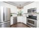 Bright kitchen features white cabinets, stainless steel appliances, granite countertops, and a window above the sink at 203 W Hill Dr, Cary, NC 27519