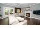 Comfortable living room with a fireplace, French doors, and neutral decor at 203 W Hill Dr, Cary, NC 27519