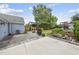 Spacious backyard featuring a stone patio, fire pit, mature trees, and a charming storage shed at 208 Maywood Ave, Raleigh, NC 27603