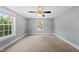 Bright carpeted bedroom with a ceiling fan and two windows offering natural light at 208 Maywood Ave, Raleigh, NC 27603