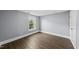 Comfortable bedroom with wood-look floors and a window with natural light at 208 Maywood Ave, Raleigh, NC 27603