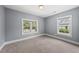 Comfortable carpeted bedroom with two windows offering natural light at 208 Maywood Ave, Raleigh, NC 27603