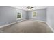 Spacious bedroom with neutral carpet and two large windows offering ample natural light at 208 Maywood Ave, Raleigh, NC 27603