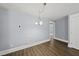 Minimalist dining room with dark wood floors and an elegant chandelier at 208 Maywood Ave, Raleigh, NC 27603