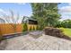 Backyard featuring a stone patio, fire pit, tasteful landscaping, and a privacy fence at 208 Maywood Ave, Raleigh, NC 27603