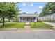 Charming blue home featuring a cozy front porch with inviting curb appeal and well-maintained lawn at 208 Maywood Ave, Raleigh, NC 27603