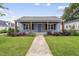 Charming blue home featuring a cozy front porch with lovely landscaping and inviting curb appeal at 208 Maywood Ave, Raleigh, NC 27603