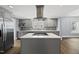 Modern kitchen features stainless steel appliances, island cooktop, and sleek countertops at 208 Maywood Ave, Raleigh, NC 27603