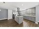 Modern kitchen with island, quartz countertops, and stainless-steel refrigerator at 208 Maywood Ave, Raleigh, NC 27603