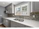 Updated kitchen with stainless steel appliances, double sink, and stylish tile backsplash at 208 Maywood Ave, Raleigh, NC 27603