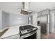 Kitchen island cooktop with a stainless steel range hood and quartz countertops at 208 Maywood Ave, Raleigh, NC 27603