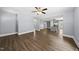 Open concept living room area with hardwood floors and a glimpse of the kitchen at 208 Maywood Ave, Raleigh, NC 27603