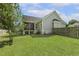 Fenced backyard featuring a well-maintained lawn, access to screened porch, and concrete foundation, perfect for outdoor enjoyment at 21 Boots Dr, Angier, NC 27501