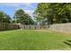 Large fenced-in backyard featuring a well-maintained lawn, providing privacy and ample space for recreation and entertaining at 21 Boots Dr, Angier, NC 27501