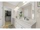 Large bathroom with white cabinets, double sinks, and a walk-in closet through an open door at 21 Boots Dr, Angier, NC 27501