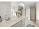 Bright bathroom featuring dual sinks, a large mirror, and a decorative vase with flowers at 21 Boots Dr, Angier, NC 27501