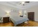 Charming bedroom with a ceiling fan, beautiful hardwood floors, and natural light at 21 Boots Dr, Angier, NC 27501