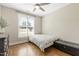 Bedroom with a window, dark hardwood floors, a ceiling fan, and a black dresser at 21 Boots Dr, Angier, NC 27501