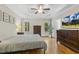 This bedroom features hardwood floors, natural light, and neutral walls with a large dresser at 21 Boots Dr, Angier, NC 27501