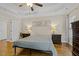 Spacious bedroom featuring hardwood floors, a tray ceiling, and neutral paint at 21 Boots Dr, Angier, NC 27501