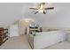 Bright bonus room featuring plush carpet, comfortable couch, television and a ceiling fan at 21 Boots Dr, Angier, NC 27501