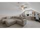 Spacious bonus room with comfortable sectional sofa, ceiling fan, and work station at 21 Boots Dr, Angier, NC 27501