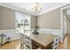 Bright dining room featuring chair rail and large windows, creating a welcoming space at 21 Boots Dr, Angier, NC 27501