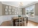Elegant dining room with wainscoting, chandelier, and ample natural light at 21 Boots Dr, Angier, NC 27501