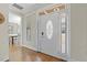 Inviting entryway with hardwood floors, sidelights, and decorative glass front door leading to the dining room at 21 Boots Dr, Angier, NC 27501