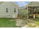 Exterior view showcasing the home's siding, access to the screened porch, and mature trees in the backyard at 21 Boots Dr, Angier, NC 27501