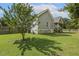 Spacious backyard featuring a well-maintained lawn, mature trees, and access to the screened porch, perfect for enjoyment at 21 Boots Dr, Angier, NC 27501
