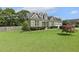 Beautiful home with stone and gray siding, dormer windows, manicured landscaping, and a lush green lawn at 21 Boots Dr, Angier, NC 27501